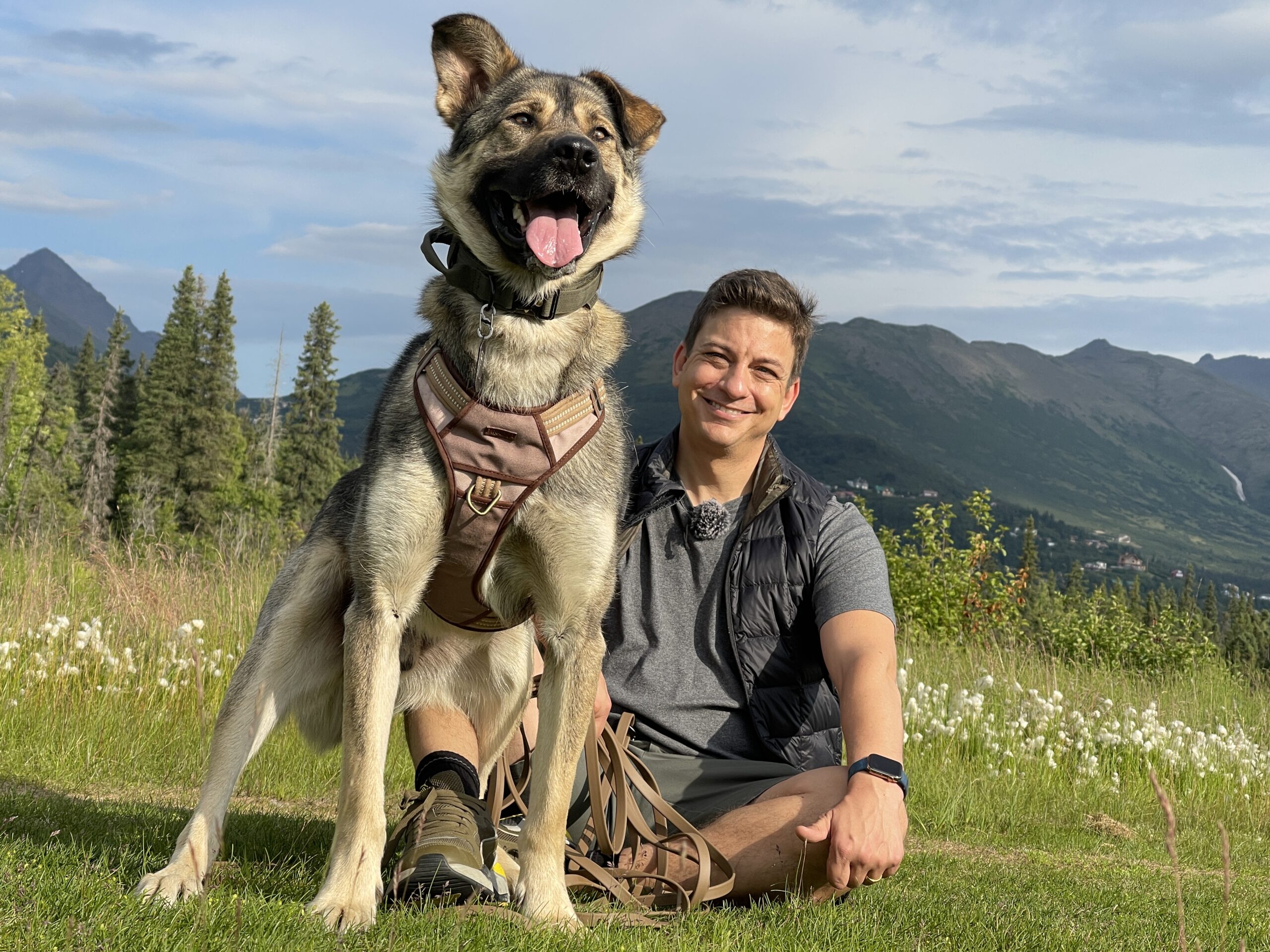 Zak George with a dog in the mountains