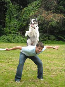Venus balances on Zak George’s back outdoors, in the Animal Fair profile.